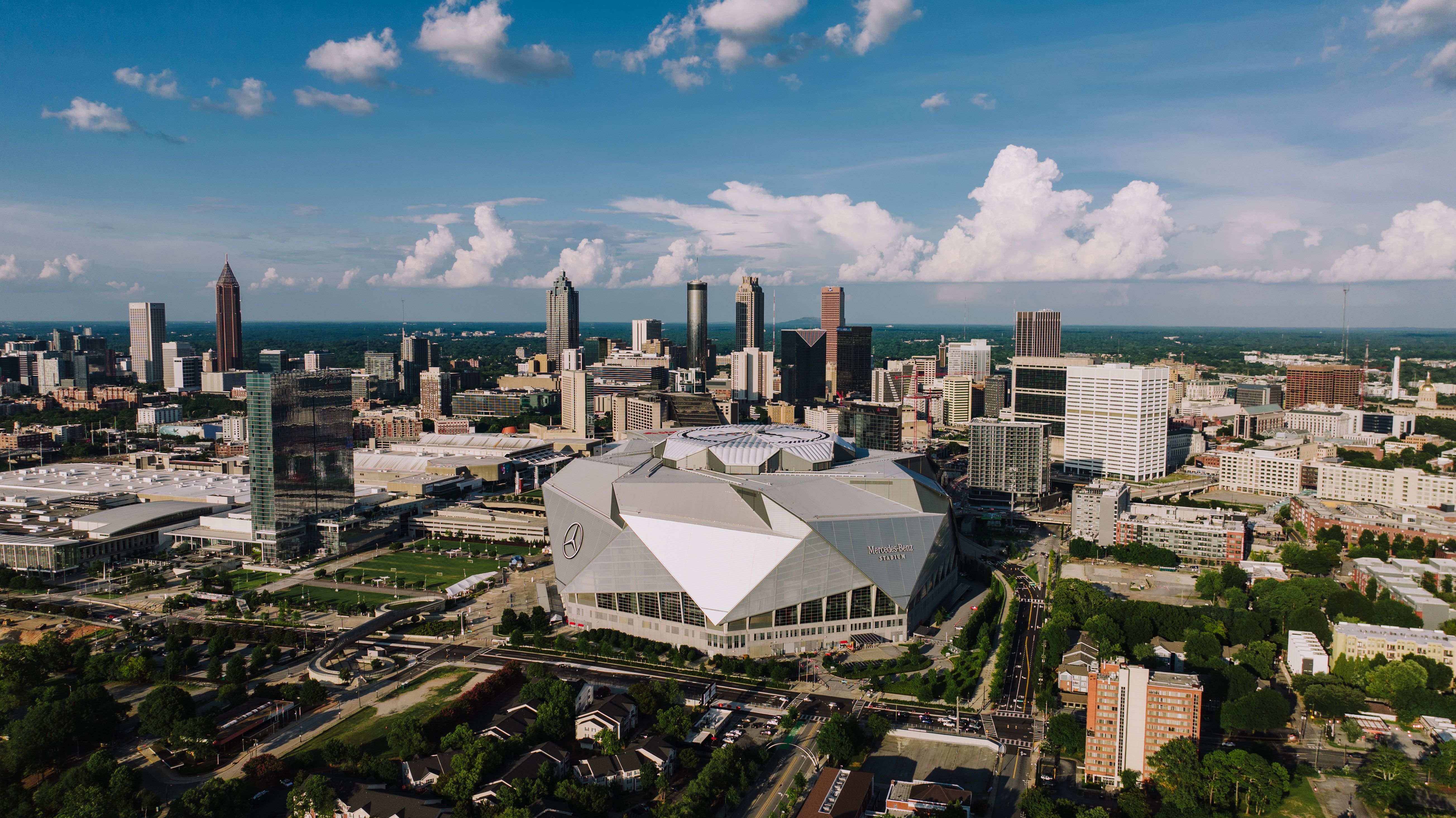 Stunning aerial view of Atlanta skyline featuring the iconic Mercedes-Benz Stadium on a clear day